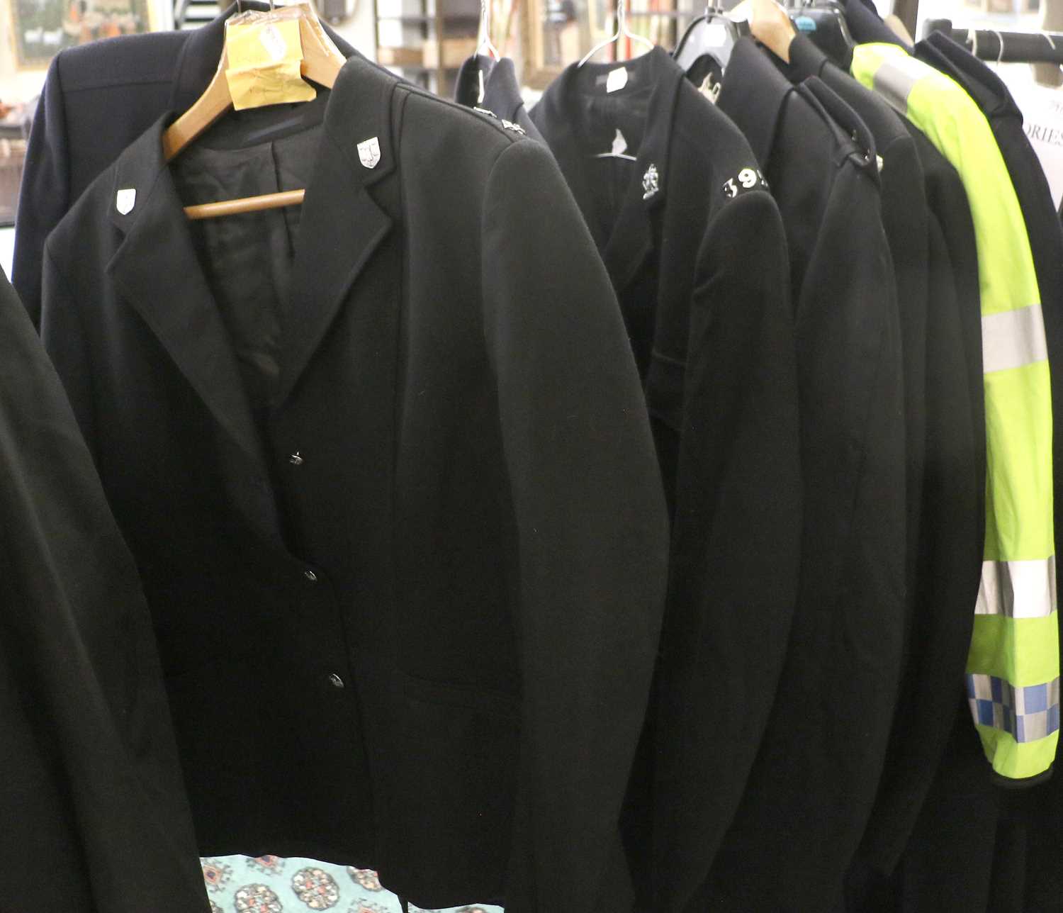 A Quantity of Police Uniforms, comprising a cape, raincoat, greatcoat, two Hi-viz jackets and a - Image 2 of 3