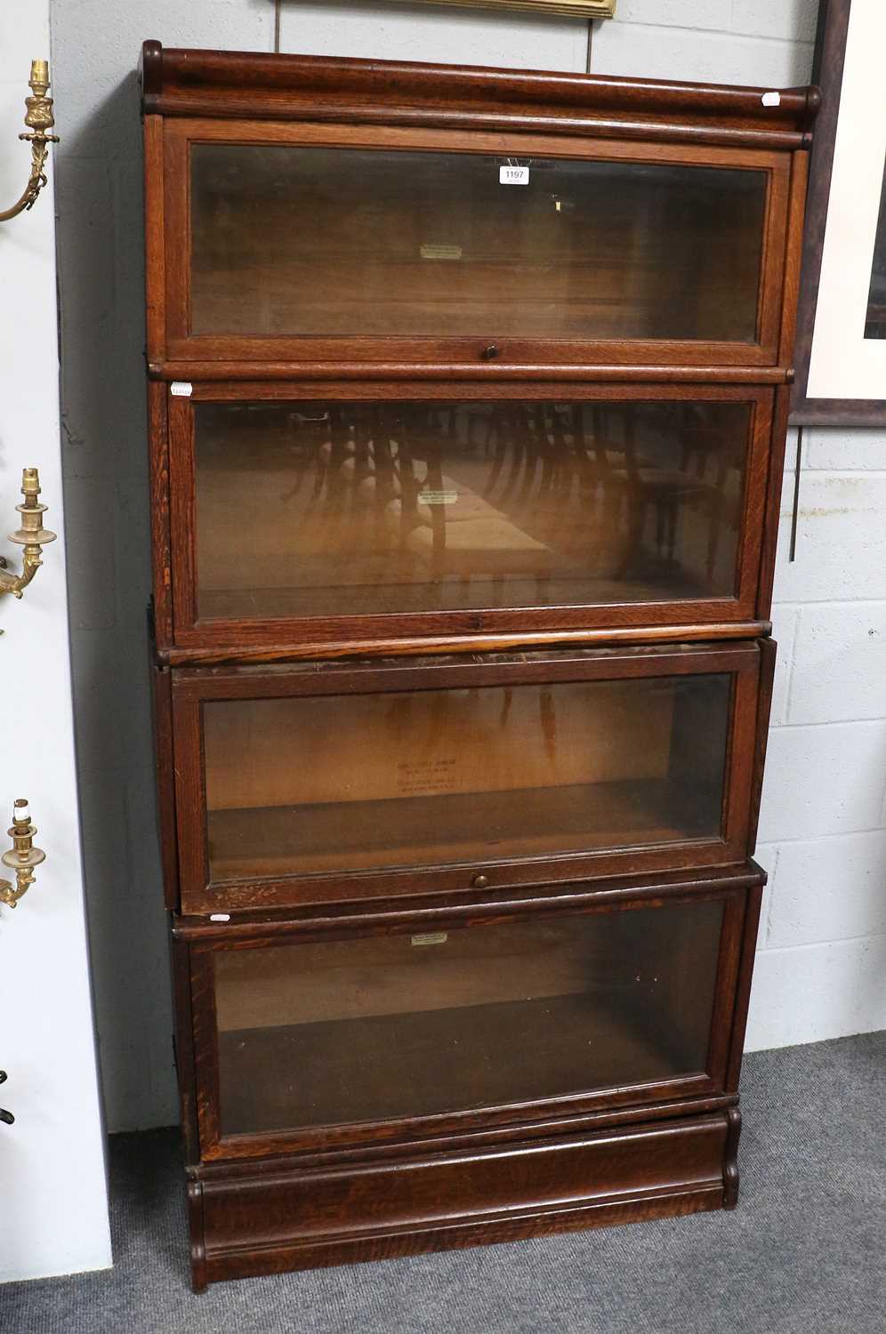 An Oak Globe Wernicke Four Tier Stacking Bookcase, three tiers labelled Globe Wernicke, one tier