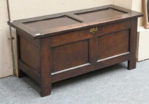 A 17th Century and Later Oak Panelled Coffer, hinged lid, candle box to interior, raised on stile