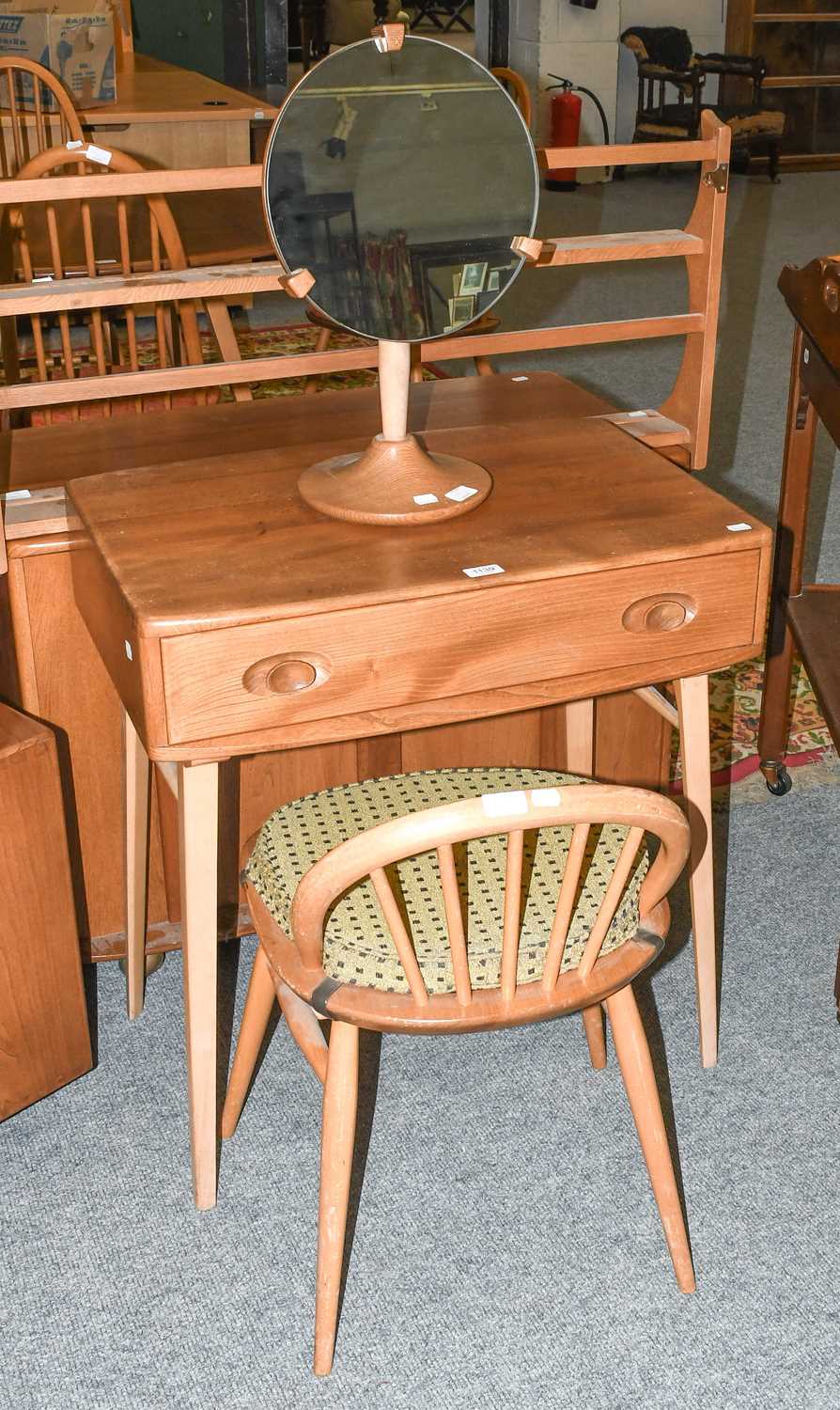 A Ercol Light Elm Dressing table, with single drawer, on splay supports with turned stretchers. 69cm