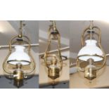A Set of Three Brass Oil Lanterns, two with opaque white shades, drop 67cm
