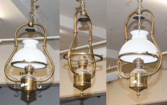 A Set of Three Brass Oil Lanterns, two with opaque white shades, drop 67cm