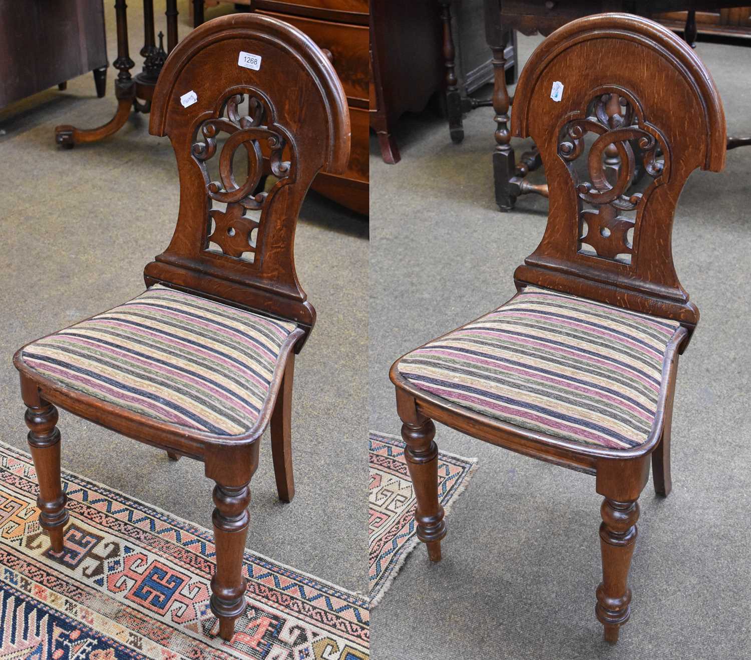 A Pair of Late 19th century Oak Hall Chairs, arched moulded backs, pierced scroll work splat,