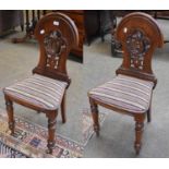 A Pair of Late 19th century Oak Hall Chairs, arched moulded backs, pierced scroll work splat,