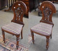 A Pair of Late 19th century Oak Hall Chairs, arched moulded backs, pierced scroll work splat,