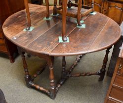 A 17th Century Gateleg Table, oval top, twin drop leaves, baluster turned legs and stretchers with