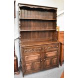 A 20th Century Carved Oak Dresser and Rack, 124cm by 45cm by 200cm