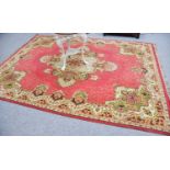 Machine Made Carpet of Oriental Design, the raspberry field centred by ivory medallion enclosed by