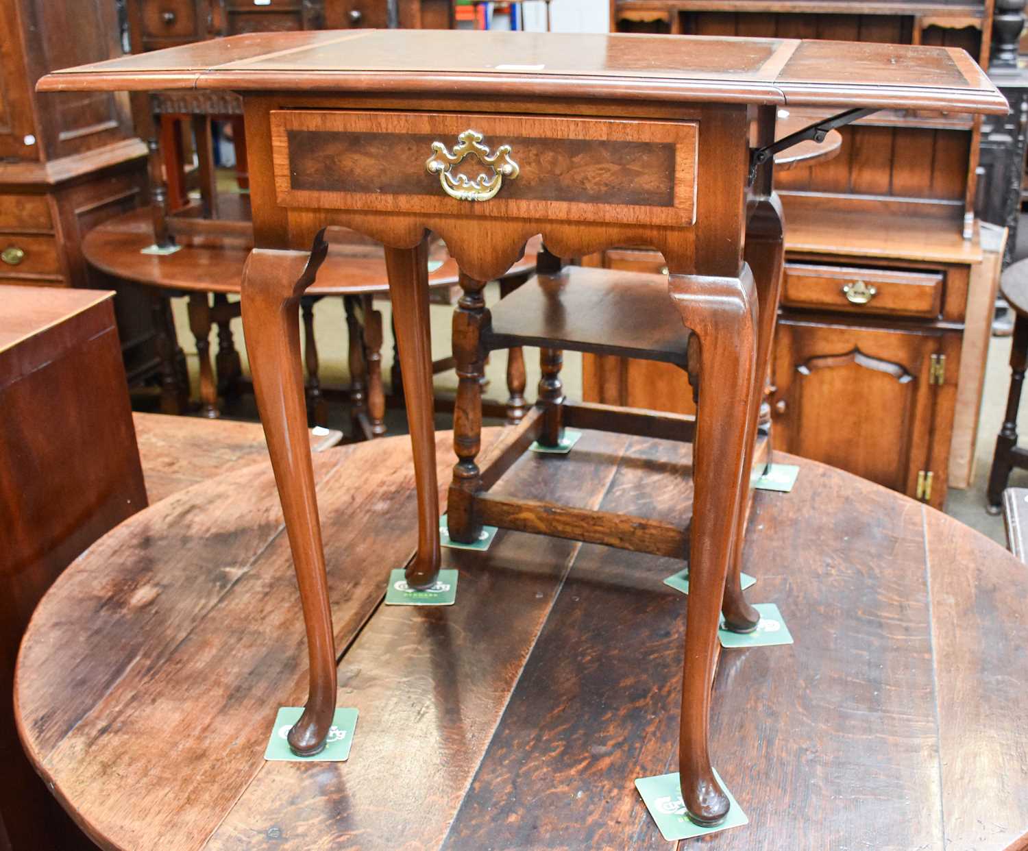 A Queen Anne Style Burr Walnut and Cross Banded Drop Leaf Lamp Table by Waring and Gillow Ltd,