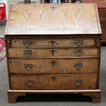 An 18th Century Walnut and Crossbanded Bureau, the fall flap opening to reveal fitted interior