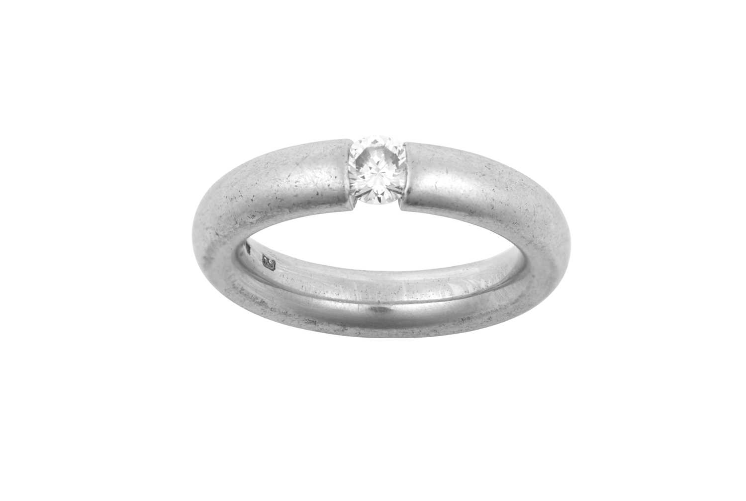 A Platinum Diamond Solitaire Ring the round brilliant cut diamond in a tension setting, to a plain