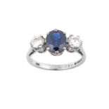 An 18 Carat White Gold Sapphire and Diamond Three Stone Ring the oval cut sapphire flanked by