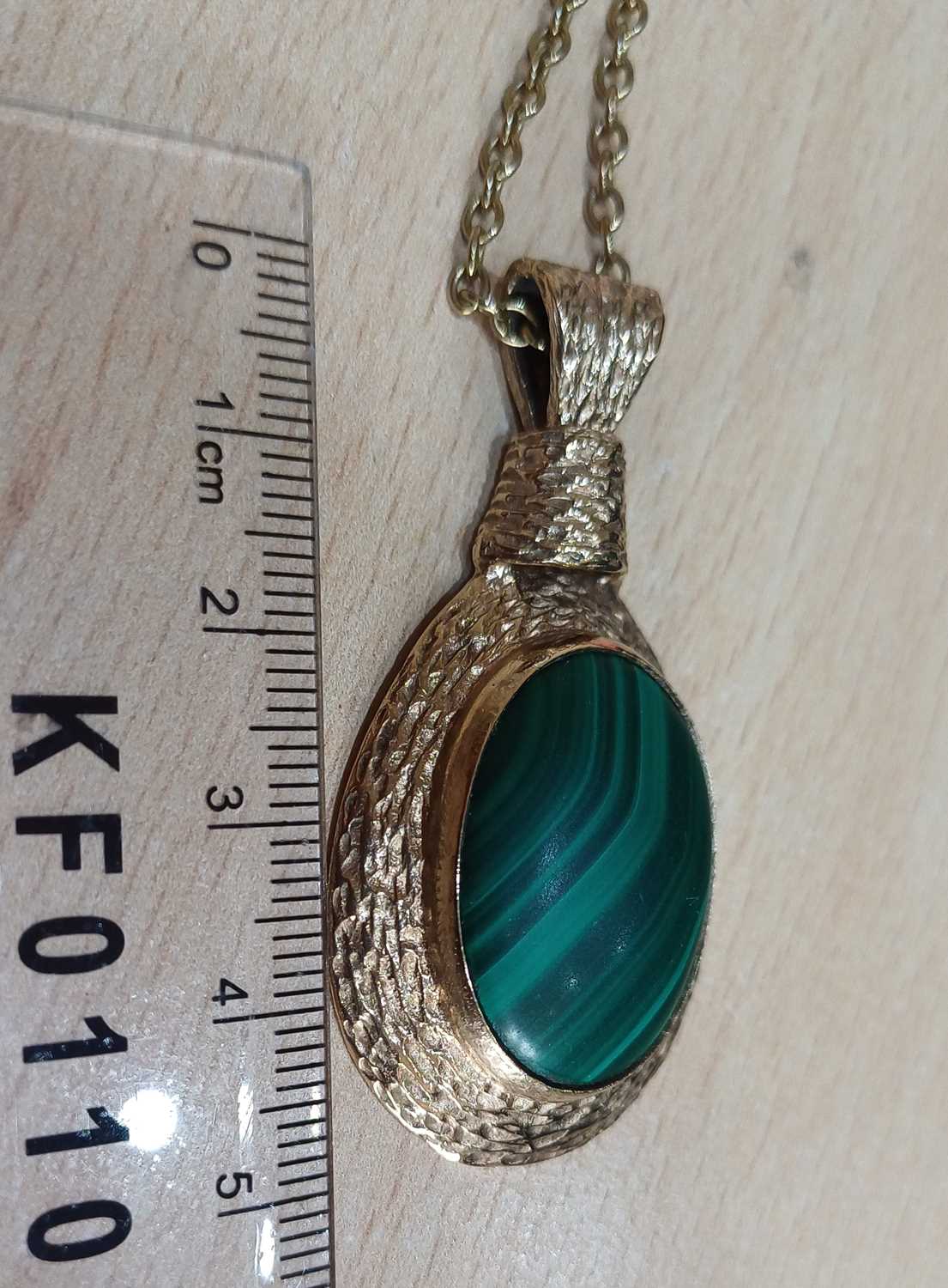 A 9 Carat Gold Malachite Pendant on Chain the oval cabochon malachite within a textured frame, - Image 2 of 4