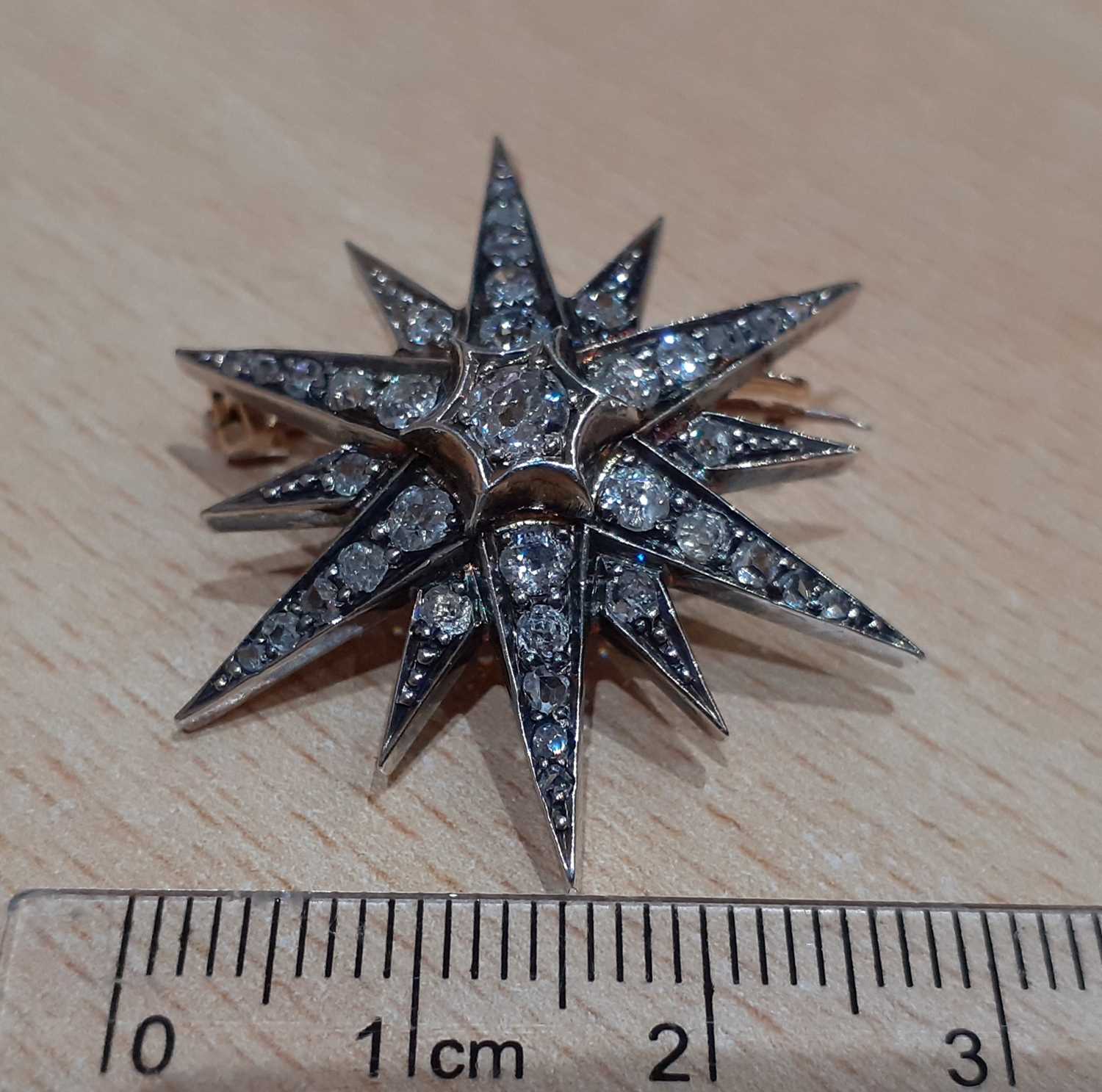 A Victorian Diamond Star Brooch/Pendant, circa 1880 an old cut diamond centres twelve radial arms, - Image 3 of 3