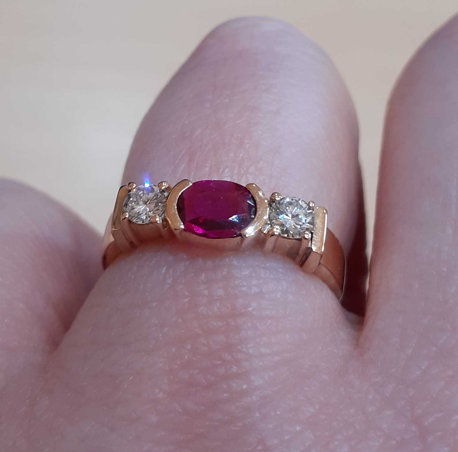 A Synthetic Ruby and Diamond Three Stone Ring the oval cut synthetic ruby in a yellow elongated claw - Image 3 of 5