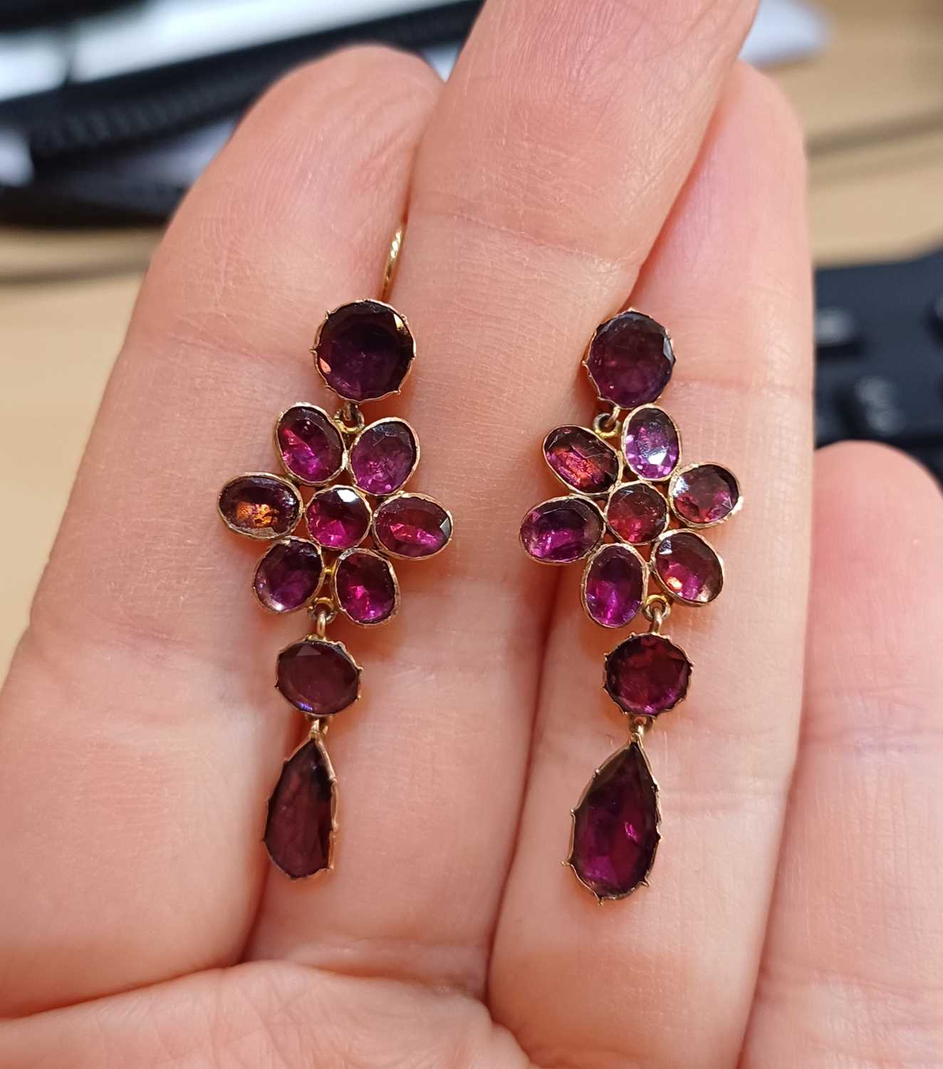 A Pair of Garnet Drop Earrings a round lasque cut garnet suspends a floral motif formed of round and - Image 3 of 3