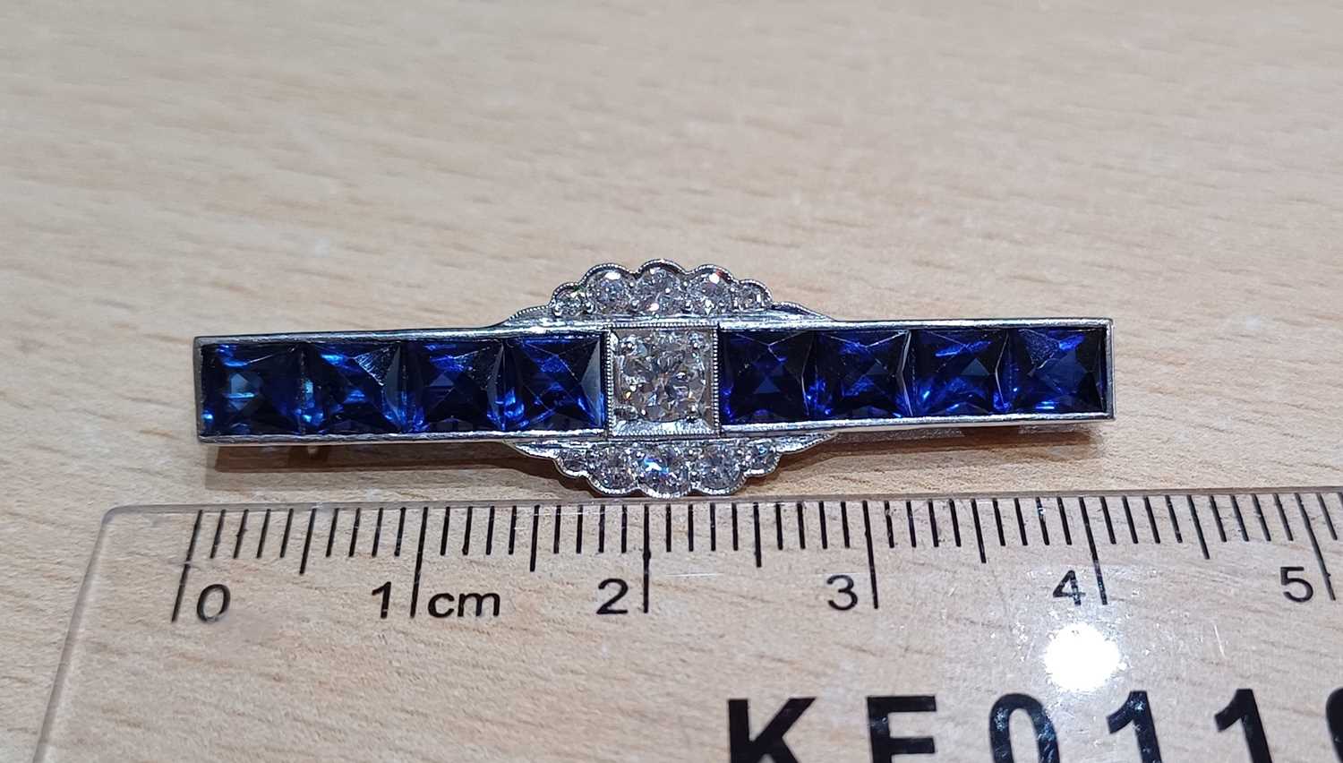 A Synthetic Sapphire and Diamond Brooch the central round brilliant cut diamond flanked by four - Image 2 of 3