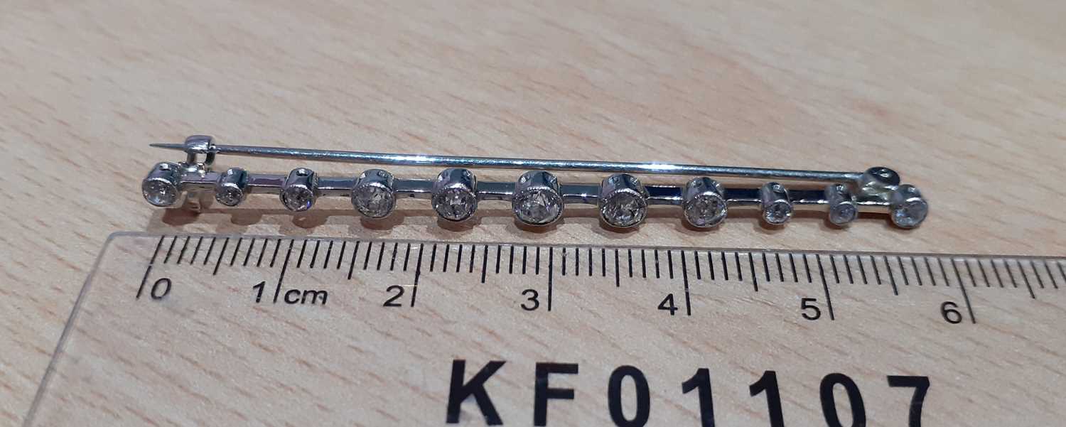 A Diamond Bar Brooch the white knife edge bar overlaid with eleven graduated old cut diamonds, in - Image 2 of 3