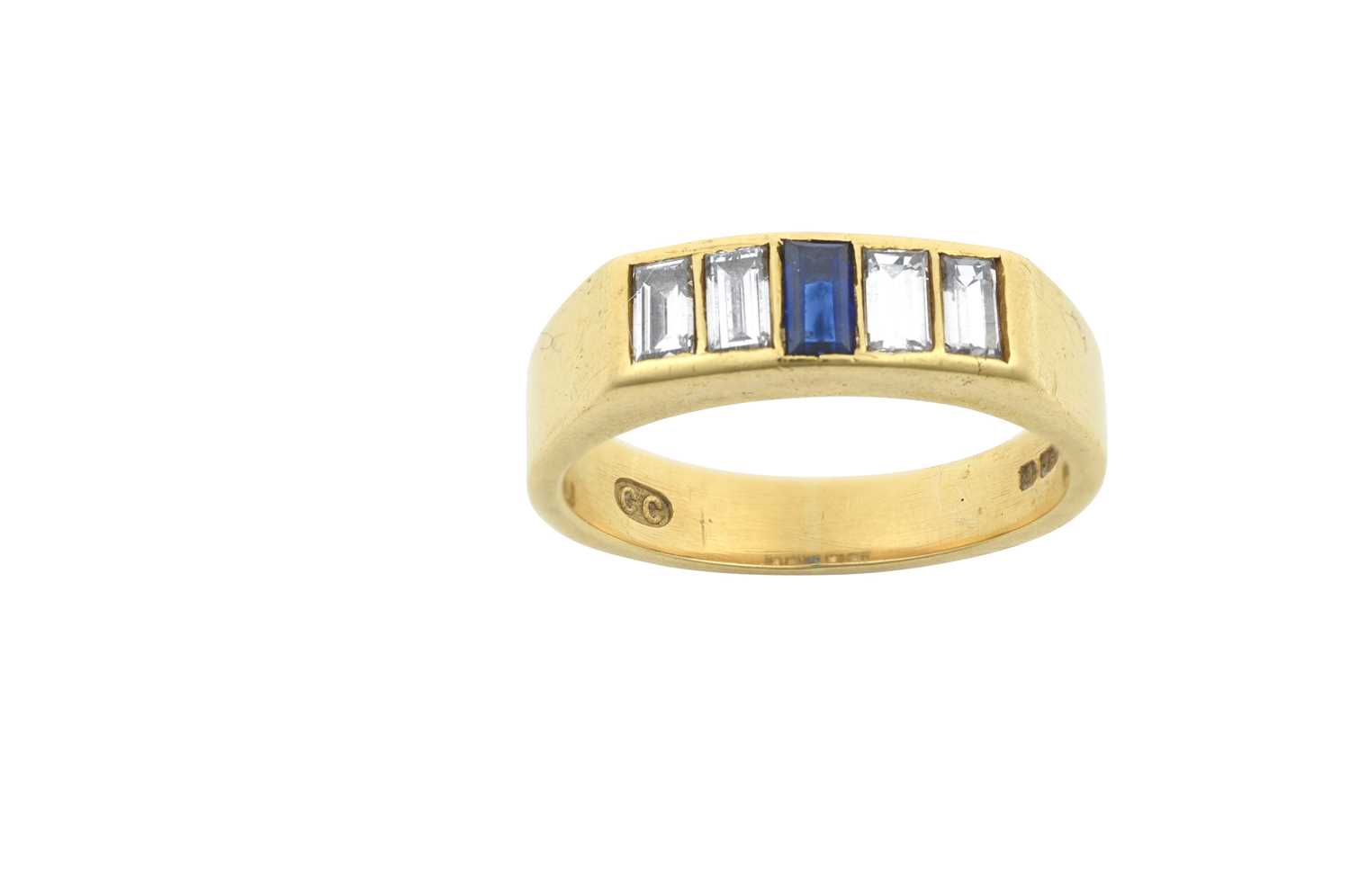 An 18 Carat Gold Sapphire and Diamond Five Stone Ring the central baguette cut sapphire flanked by