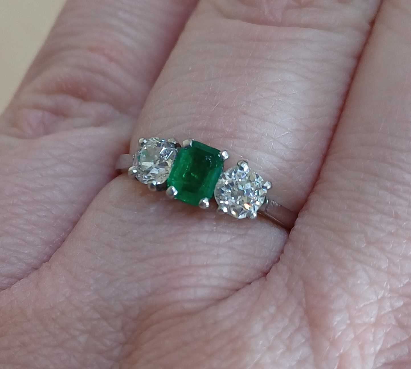 An Emerald and Diamond Three Stone Ring the emerald-cut emerald flanked by old cut diamonds, in - Image 2 of 4