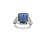 A Synthetic Sapphire and Diamond Ring the emerald-cut synthetic sapphire in a white four claw
