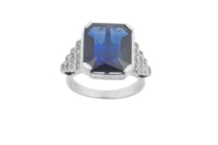 A Synthetic Sapphire and Diamond Ring the emerald-cut synthetic sapphire in a white four claw