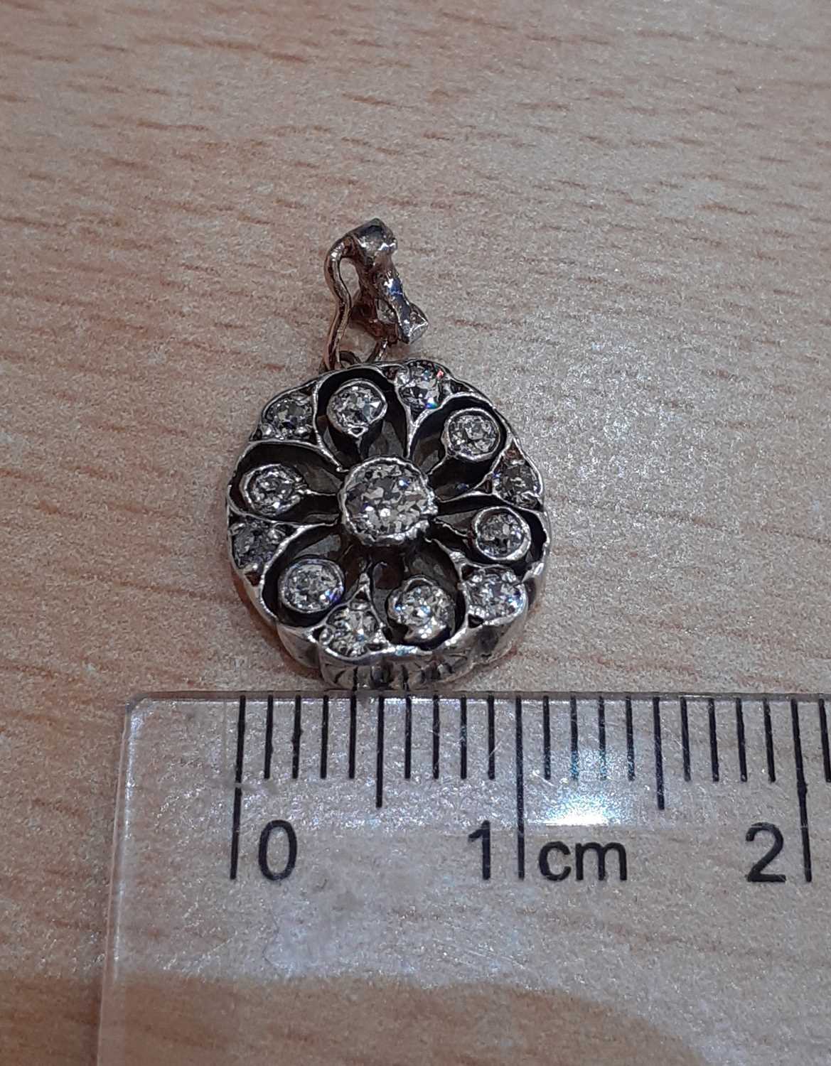 A Diamond Pendant the central old cut diamond to a circular openwork frame set throughout with old - Image 2 of 3