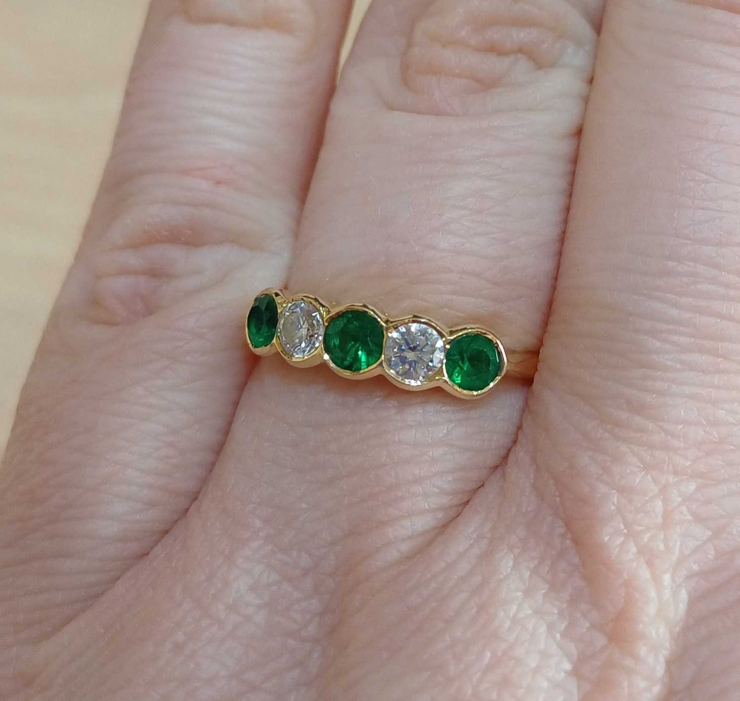 An 18 Carat Gold Emerald and Diamond Five Stone Ring three round cut emeralds alternate with two - Image 2 of 4