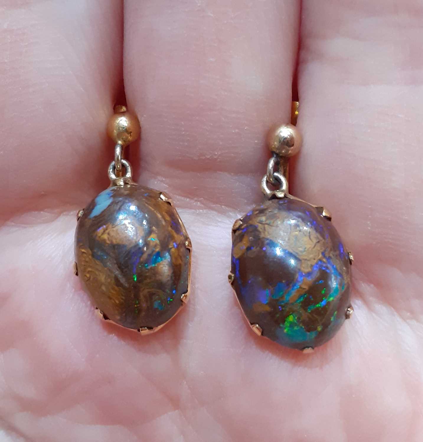 A Pair of Opal Earrings the oval cabochon boulder opals in yellow claw settings, surmounted by a - Image 2 of 4