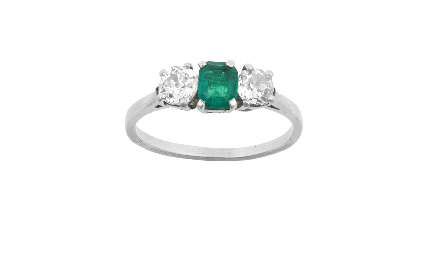 An Emerald and Diamond Three Stone Ring the emerald-cut emerald flanked by old cut diamonds, in