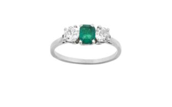 An Emerald and Diamond Three Stone Ring the emerald-cut emerald flanked by old cut diamonds, in