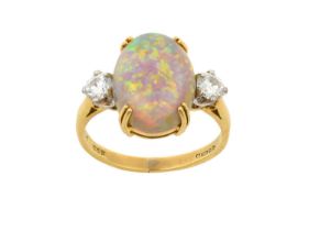 An 18 Carat Gold Opal and Diamond Three Stone Ring the oval cabochon opal in a yellow double claw