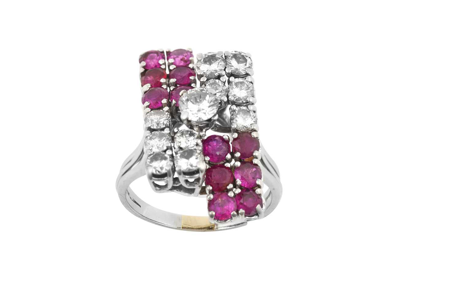 A Ruby and Diamond Cluster Ring a raised round brilliant cut diamond, to a geometric motif, formed