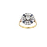 A Synthetic Sapphire and Diamond Cluster Ring the central raised round brilliant cut diamond