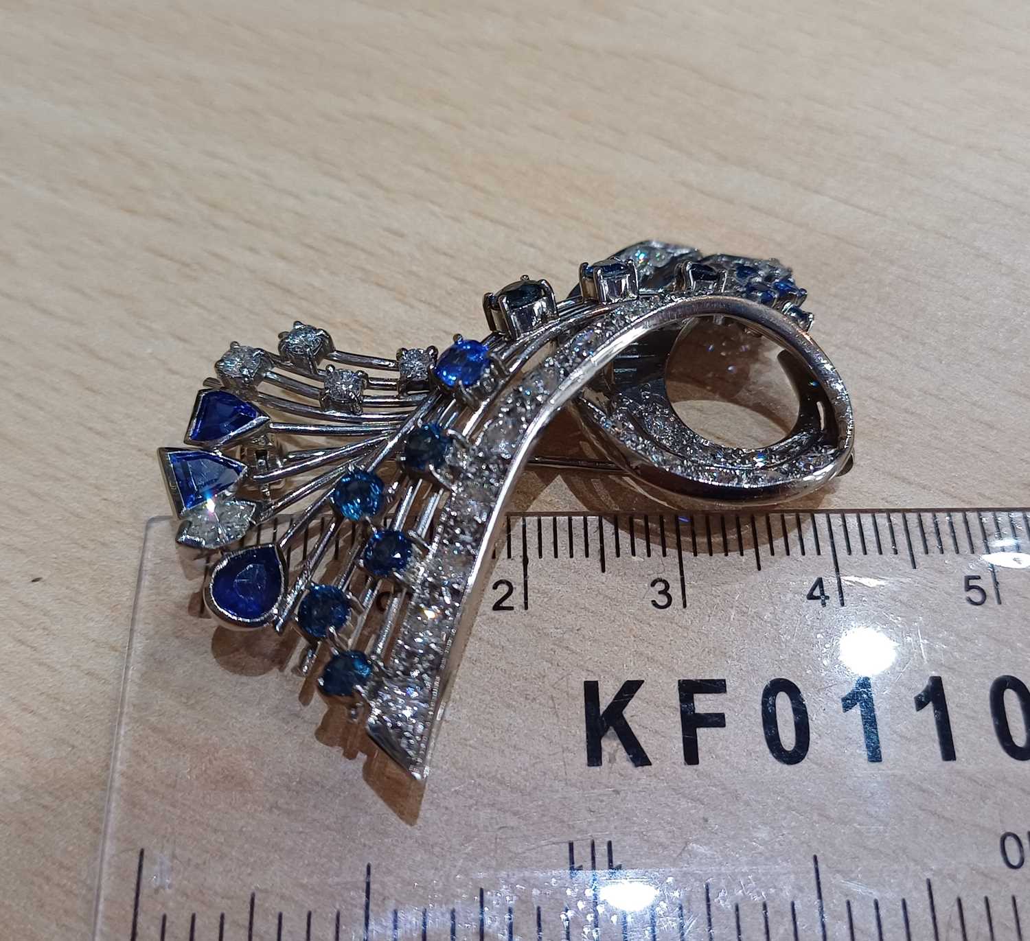 A Sapphire and Diamond Brooch modelled as a ribbon motif, set throughout with vari-shaped - Image 2 of 4