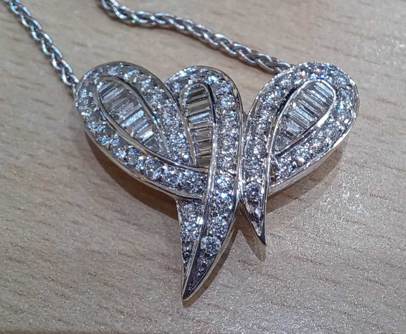 An 18 Carat Gold Diamond Pendant on Chain the stylised ribbon motif set throughout with baguette cut - Image 3 of 4