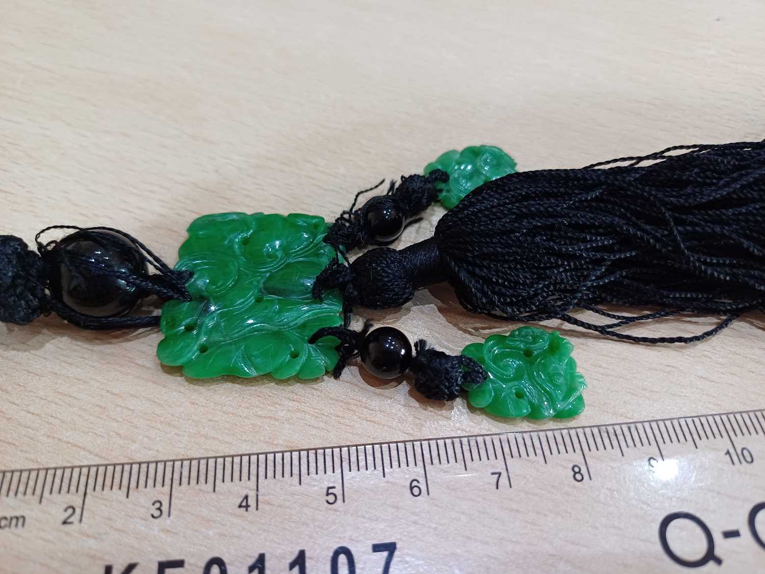 A Jade and Onyx Tassel Necklace an onyx bead suspends a rectangular carved and pierced jade - Image 3 of 16