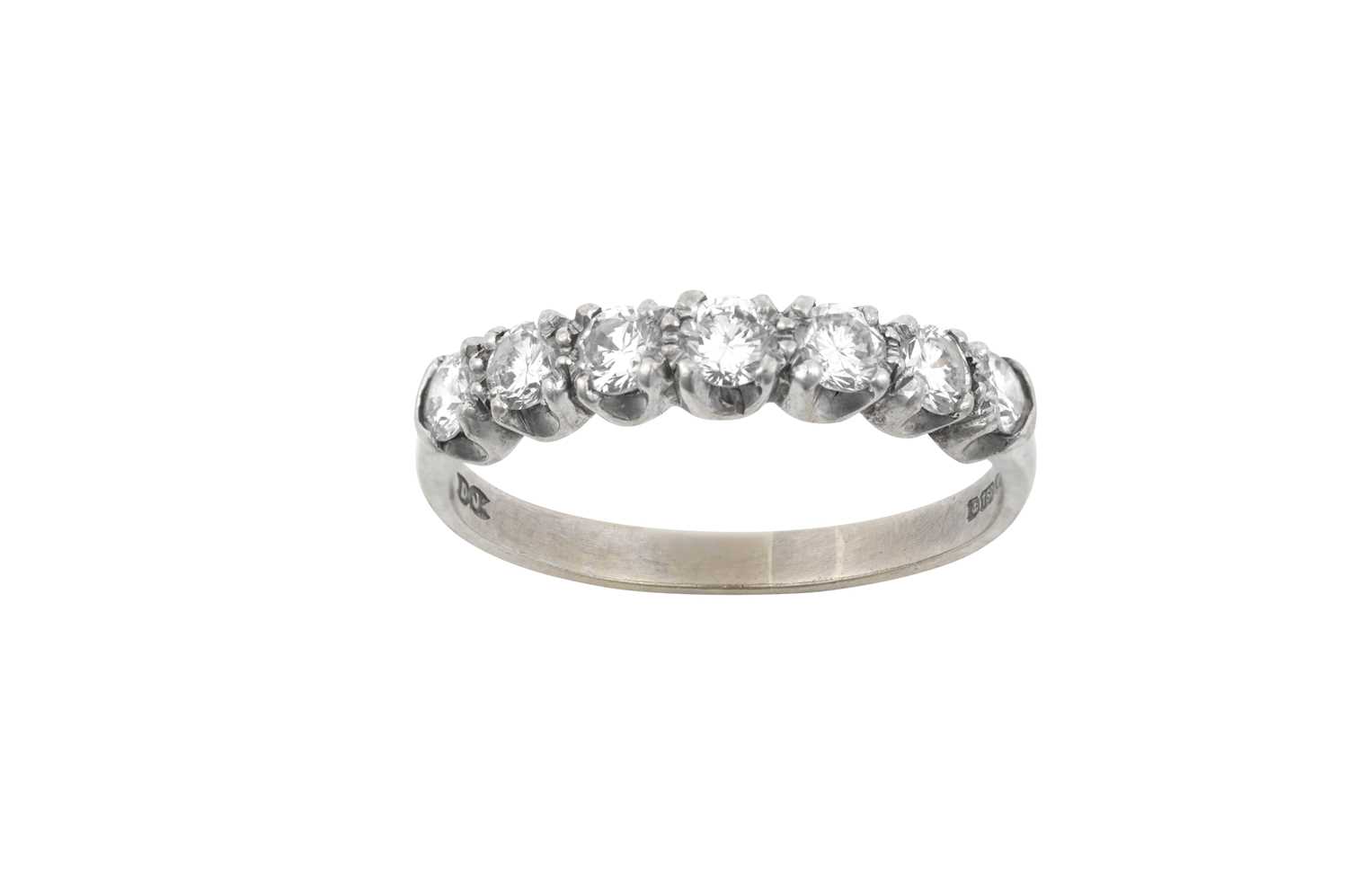 An 18 Carat White Gold Diamond Half Hoop Ring seven round brilliant cut diamonds in claw settings,