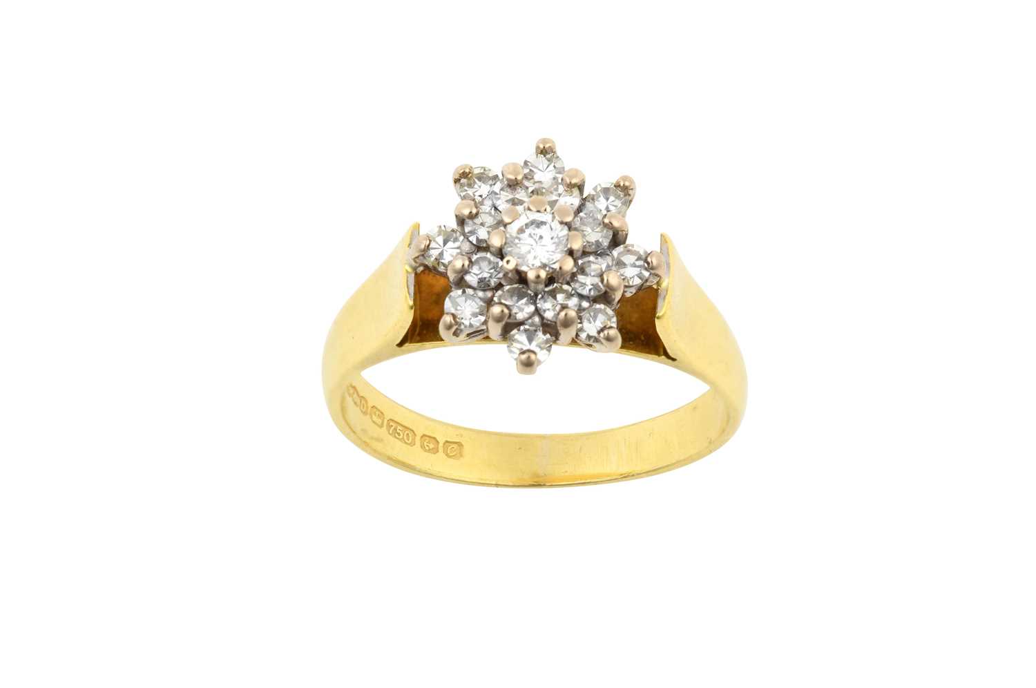 An 18 Carat Gold Diamond Cluster Ring the central raised round brilliant cut diamond within a double