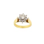 An 18 Carat Gold Diamond Cluster Ring the central raised round brilliant cut diamond within a double