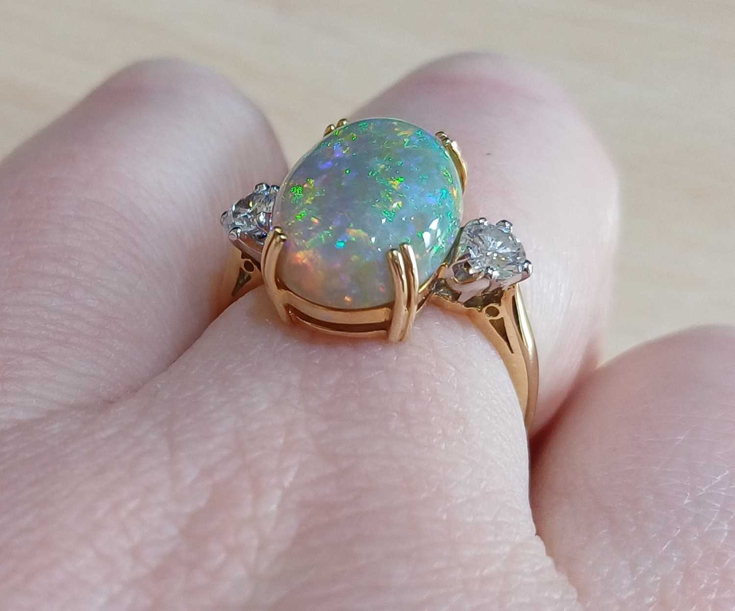 An 18 Carat Gold Opal and Diamond Three Stone Ring the oval cabochon opal in a yellow double claw - Image 2 of 4