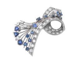 A Sapphire and Diamond Brooch modelled as a ribbon motif, set throughout with vari-shaped
