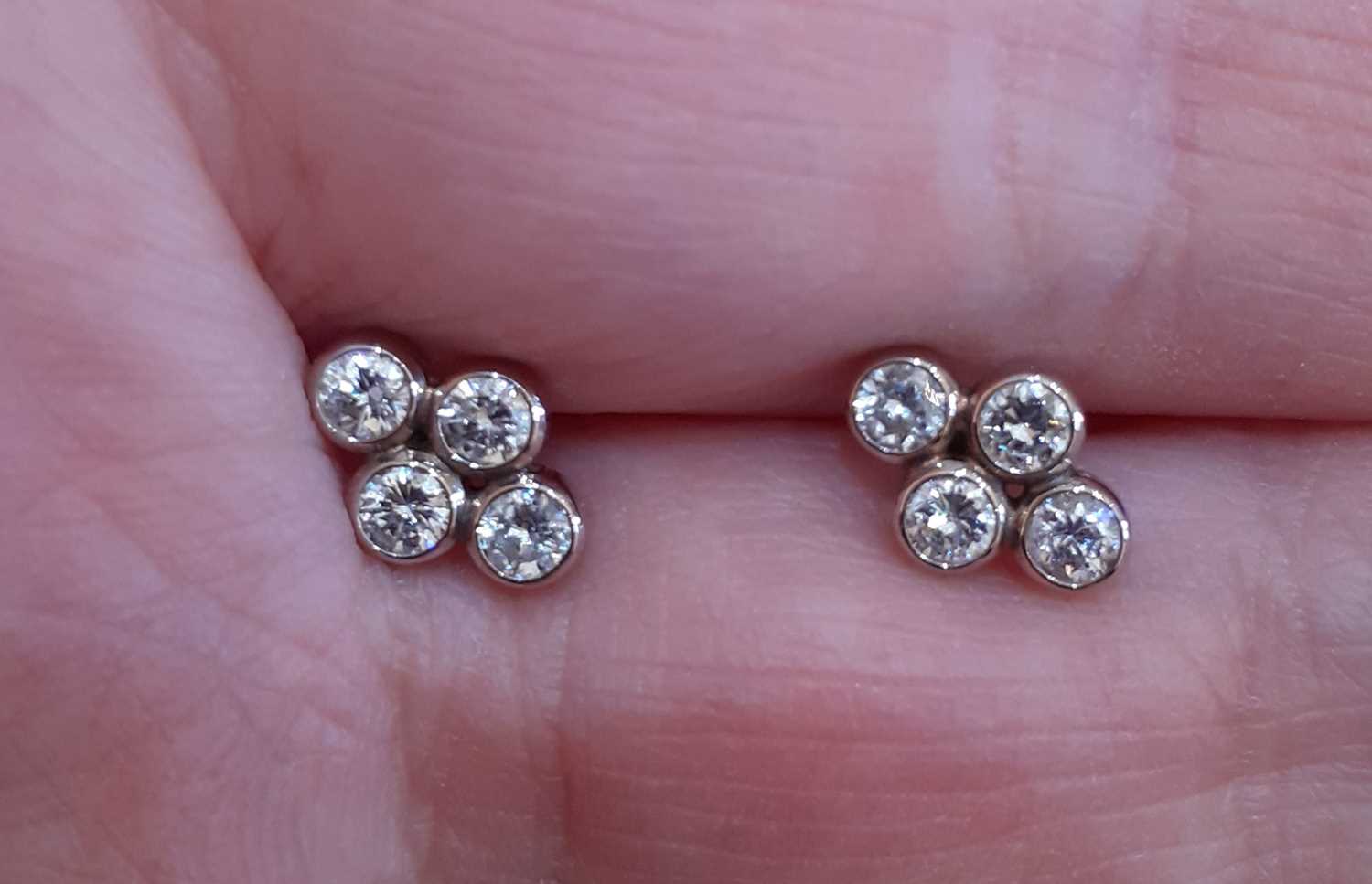A Pair of Diamond Cluster Earrings four round brilliant cut diamonds in white rubbed over - Image 3 of 4