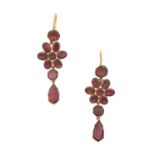 A Pair of Garnet Drop Earrings a round lasque cut garnet suspends a floral motif formed of round and