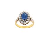 A Sapphire and Diamond Cluster Ring the oval cut sapphire within a border of old cut diamonds, in