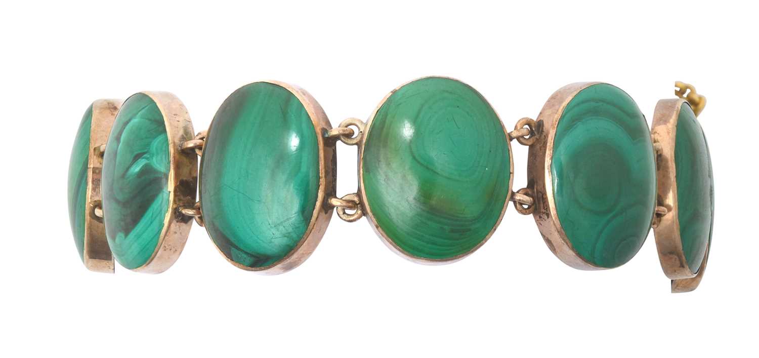 A Malachite Bracelet the eleven chain linked oval malachite plaques in yellow rubbed over settings