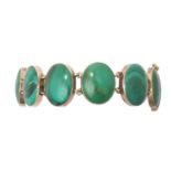 A Malachite Bracelet the eleven chain linked oval malachite plaques in yellow rubbed over settings