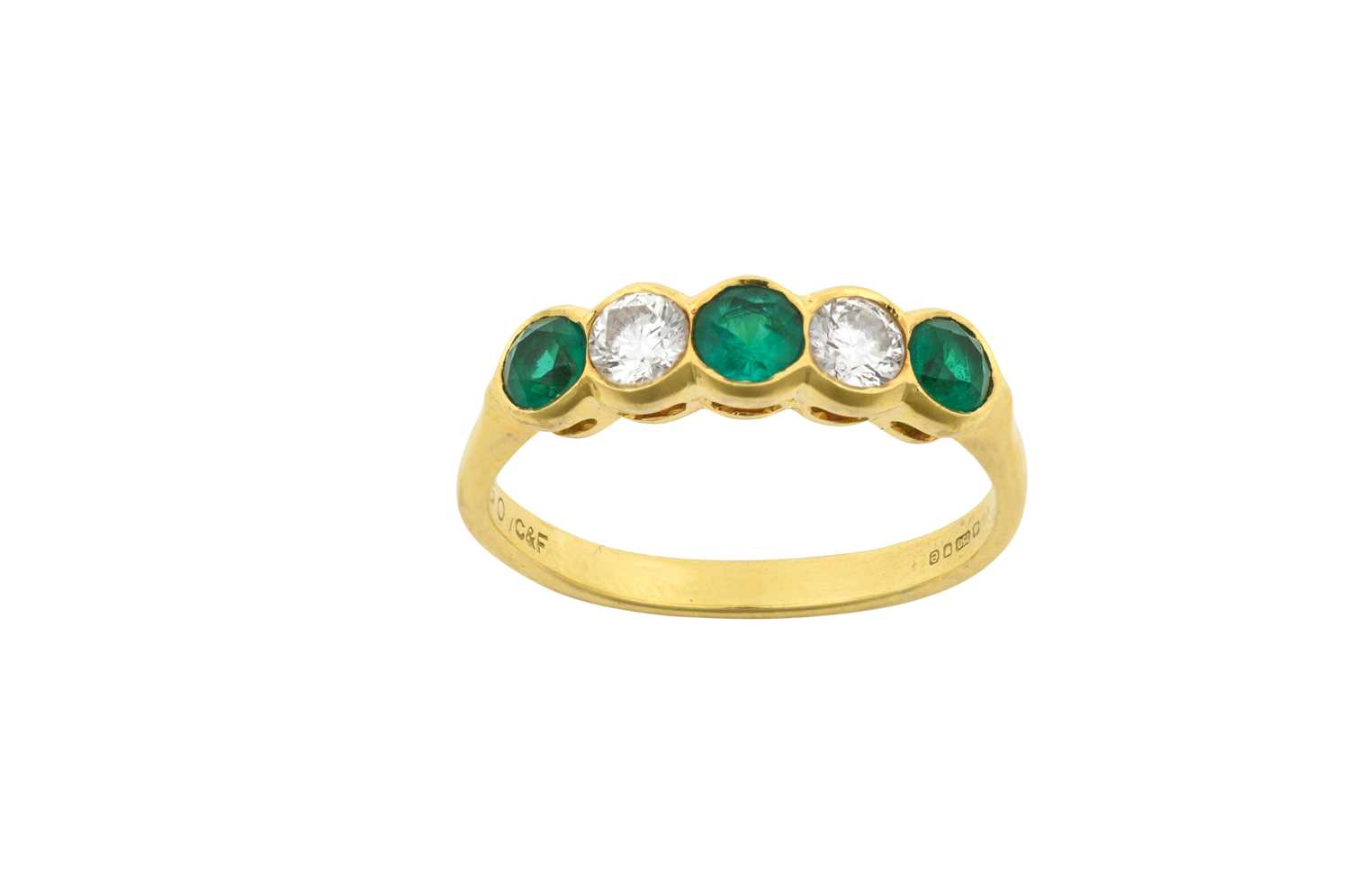 An 18 Carat Gold Emerald and Diamond Five Stone Ring three round cut emeralds alternate with two