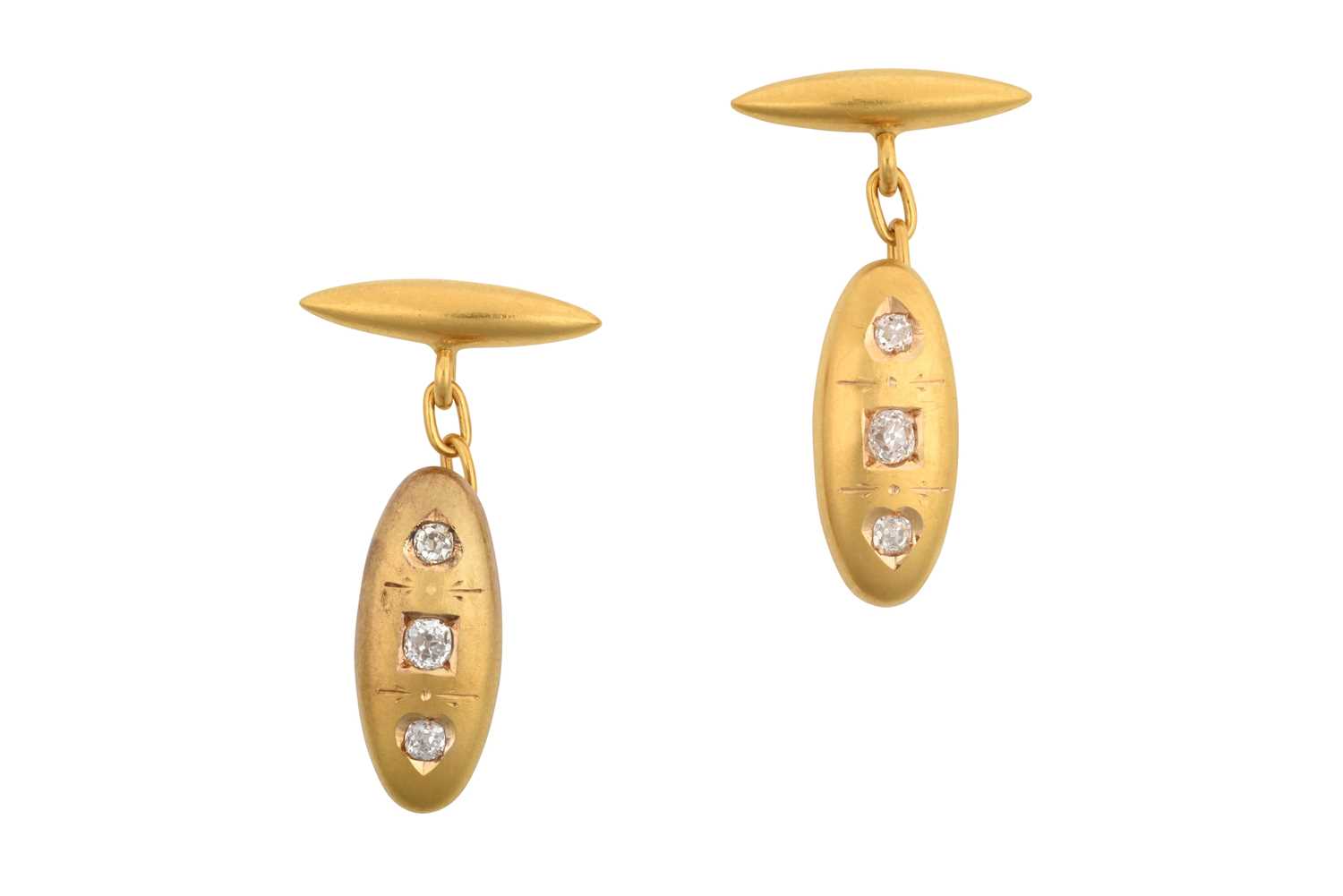A Pair of Diamond Cufflinks the yellow domed oval plaque inset with three old cut diamonds, chain