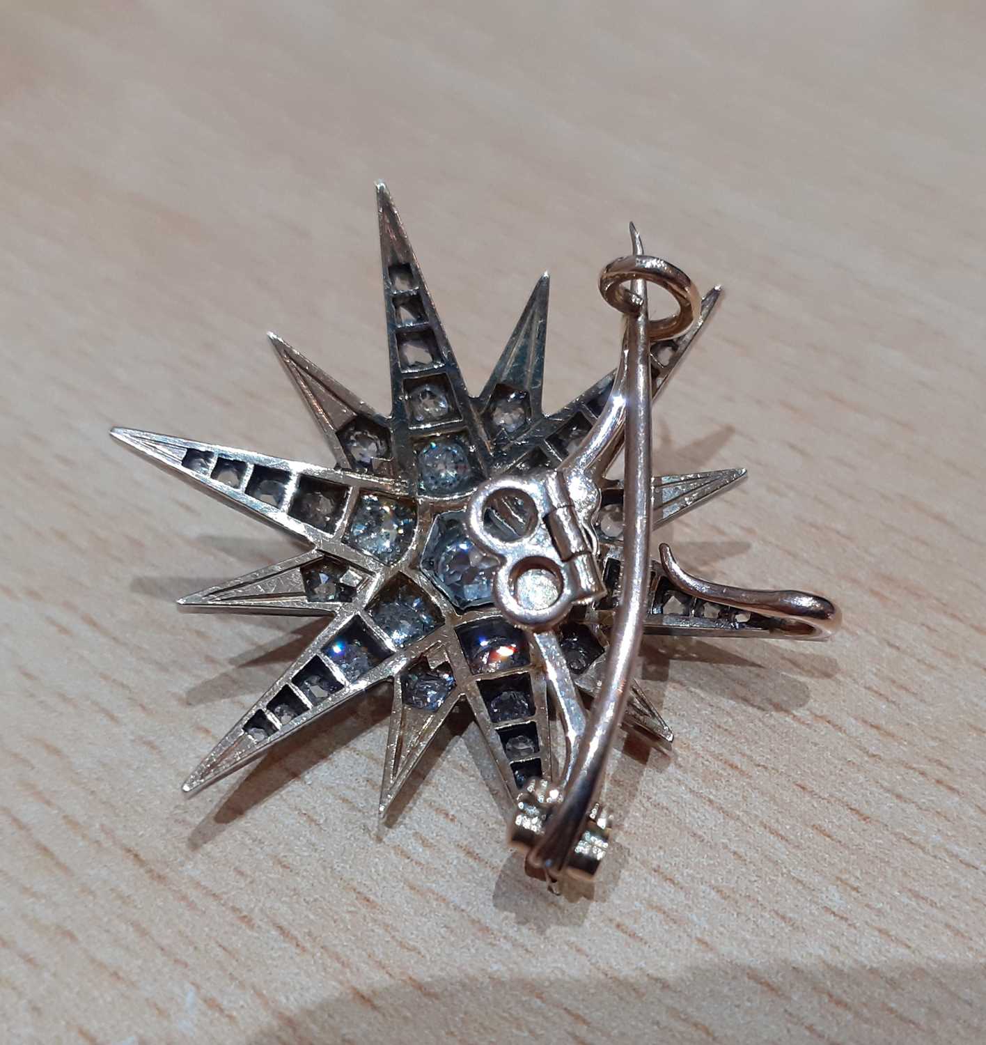 A Victorian Diamond Star Brooch/Pendant, circa 1880 an old cut diamond centres twelve radial arms, - Image 2 of 3